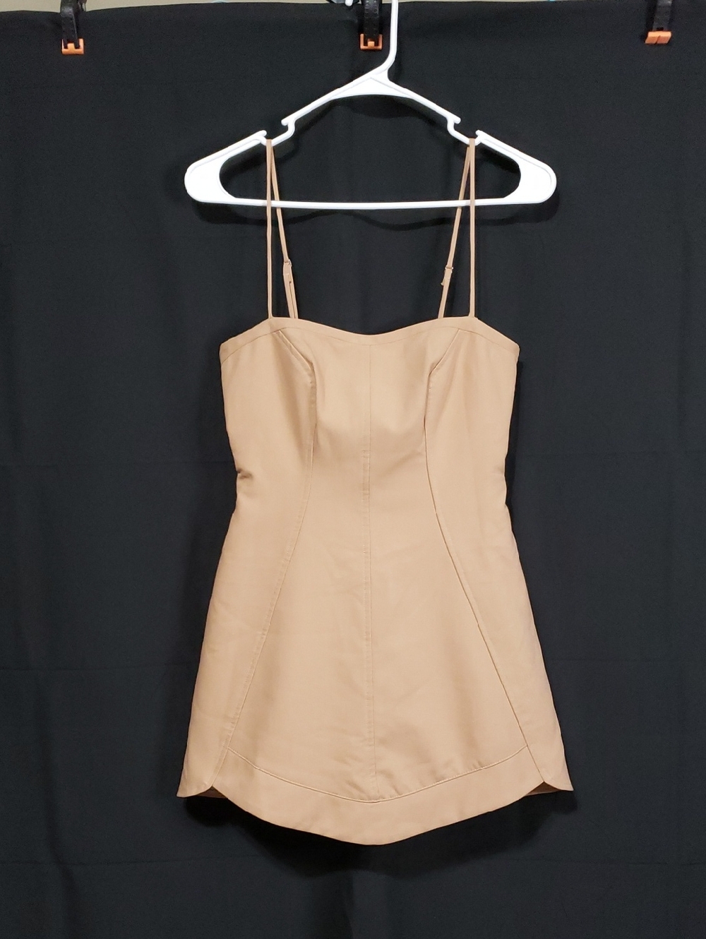 Beige Sleeveless Corset-Style Mini Dress With A Scalloped Hem.